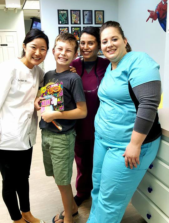dr. ellen im pediatric dentistry smiling with patient